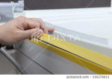 Masking when replacing caulking in the bathroom Masking when replacing caulking in the bathroom 138170611