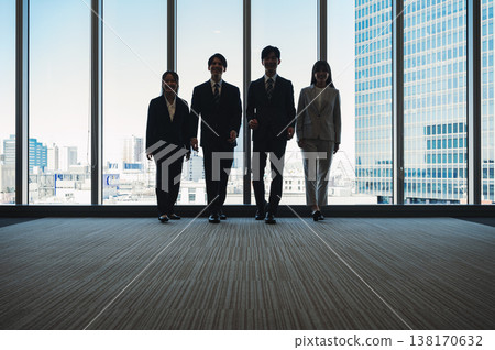 Silhouettes of young men and women in suits Silhouettes of young men and women in suits 138170632