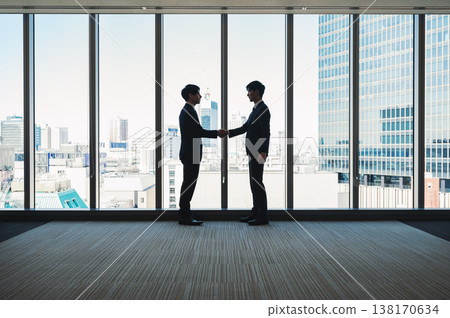 Silhouette of a businessman shaking hands Silhouette of a businessman shaking hands 138170634