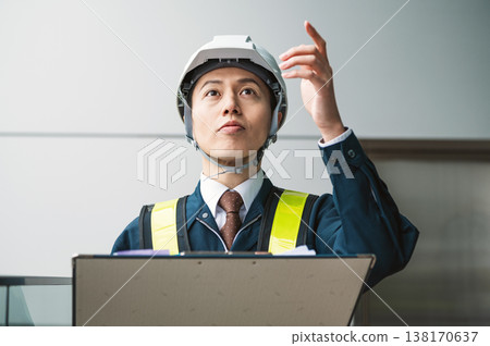 一位男性建築經理正在檢查某物。 138170637
