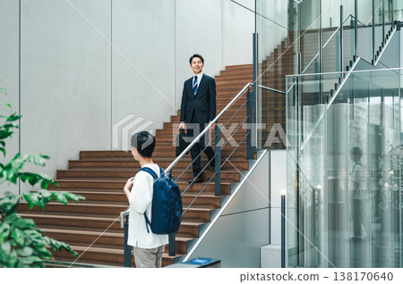 Businessman walking up the stairs of an office building Businessman walking up the stairs of an office building 138170640