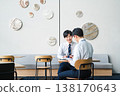 Young businessmen having a meeting in a free space in an office building. 138170643