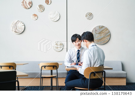 Young businessmen having a meeting in a free space in an office building. Young businessmen having a meeting in a free space in an office building. 138170643