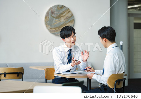 Young businessmen having a meeting in a free space in an office building. Young businessmen having a meeting in a free space in an office building. 138170646
