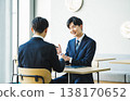 A young businessman using gestures and body language during a business negotiation. 138170652