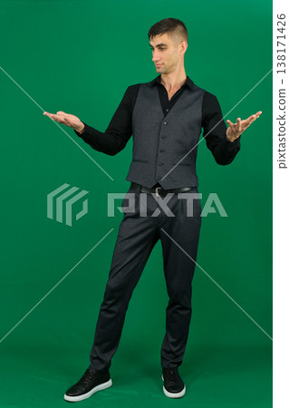 emotions of handsome man guy on a green background chromakey close-up dark hair young man 138171426