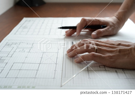 A Japanese architect drawing architectural plans 138171427