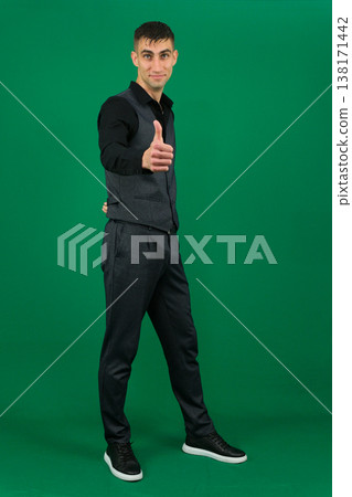 emotions of handsome man guy on a green background chromakey close-up dark hair young man emotions of handsome man guy on a green background chromakey close-up dark hair young man 138171442