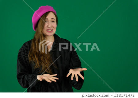 Beautiful young woman looking woman on a green background chromakey in a black striped mens shirt different emotions facial expression close-up advertising space for text clean. kind eyes 138171472