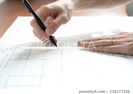 A Japanese architect drawing architectural plans A Japanese architect drawing architectural plans 138171508