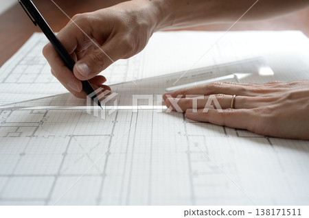 A Japanese architect drawing architectural plans A Japanese architect drawing architectural plans 138171511
