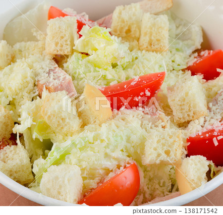 Fresh caesar salad with chicken crouton and cherry tomato in craft paper take out bowl top view extreme close up flat lay delicious snack food 138171542