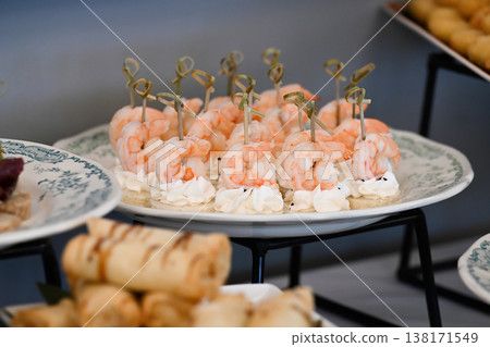 Assorted catering appetizer with shrimp canape and cream cheese on skewer for event or party decoration with delicious seafood snack on buffet table Assorted catering appetizer with shrimp canape and cream cheese on skewer for event or party decoration with delicious seafood snack on buffet table 138171549
