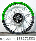 Bicolor green and black motorcycle wheel rim with silver spoke and hub isolated on white background for custom motorbike tuning and spare part repair 138171553