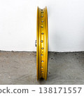 Gold motorcycle wheel rim side view isolated on white background with silver spoke nipple and metal hub for motorbike custom tuning and repair part 138171557