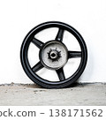 Black motorcycle wheel rim cast alloy five spoke design rear view with silver metal hub isolated on white background for motorbike repair and tuning 138171562