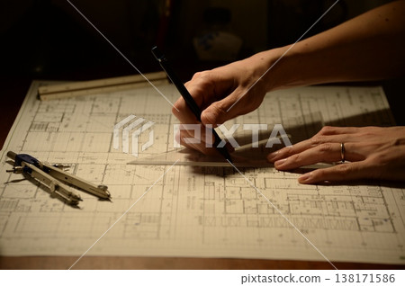 The hands of a Japanese architect drawing architectural drawings at night The hands of a Japanese architect drawing architectural drawings at night 138171586
