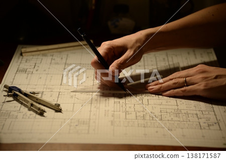 The hands of a Japanese architect drawing architectural drawings at night The hands of a Japanese architect drawing architectural drawings at night 138171587