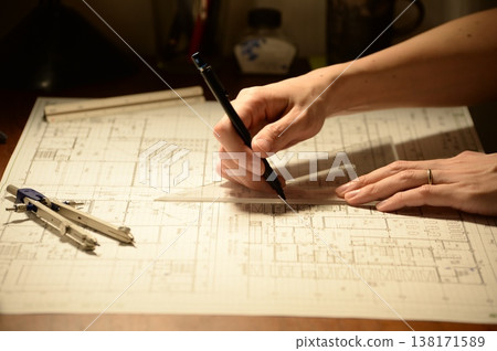 The hands of a Japanese architect drawing architectural drawings at night The hands of a Japanese architect drawing architectural drawings at night 138171589