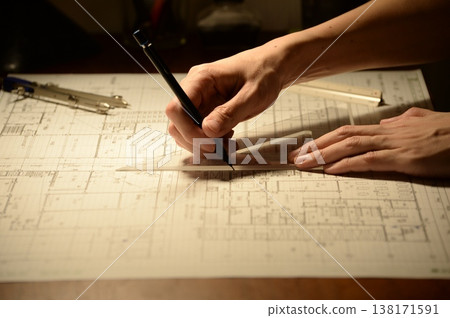 The hands of a Japanese architect drawing architectural drawings at night The hands of a Japanese architect drawing architectural drawings at night 138171591