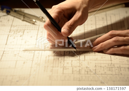 The hands of a Japanese architect drawing architectural drawings at night The hands of a Japanese architect drawing architectural drawings at night 138171597