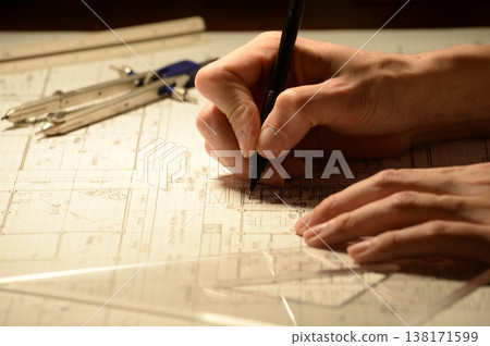 The hands of a Japanese architect drawing architectural drawings at night The hands of a Japanese architect drawing architectural drawings at night 138171599
