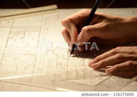 The hands of a Japanese architect drawing architectural drawings at night The hands of a Japanese architect drawing architectural drawings at night 138171600