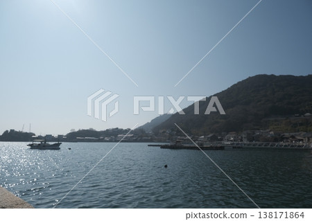 A tranquil harbor and ships, a coastal landscape with mountains and townscapes. A tranquil harbor and ships, a coastal landscape with mountains and townscapes. 138171864