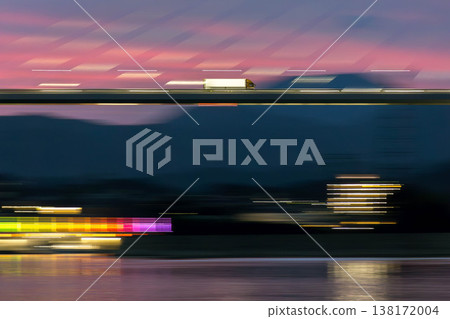 Panning shot of a truck crossing a bridge in the evening. Panning shot of a truck crossing a bridge in the evening. 138172004