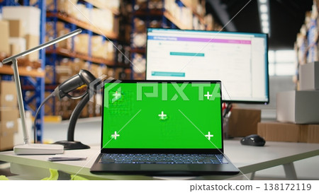 Empty warehouse depot running green screen on computer display, handling order processing and shipping e-commerce cargo products. Storage room with industrial racks and shelves. Empty warehouse depot running green screen on computer display, handling order processing and shipping e-commerce cargo products. Storage room with industrial racks and shelves. 138172119