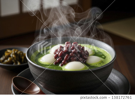 A rich matcha mochi zenzai with steaming hot, featuring a vibrant green color and glossy red beans – a beautiful Japanese sweet. 138172761