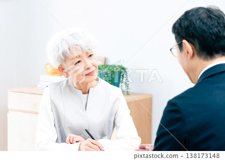 Senior woman listening to a salesperson's explanation Senior woman listening to a salesperson's explanation 138173148