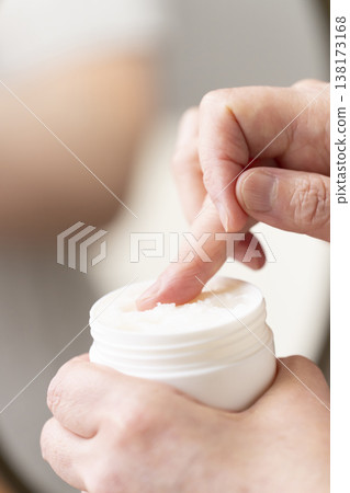 A woman's hands applying makeup. A woman's hands applying makeup. 138173168