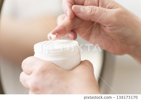 A woman's hands applying makeup. 138173170