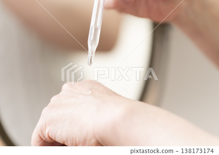 A woman's hands applying makeup. A woman's hands applying makeup. 138173174