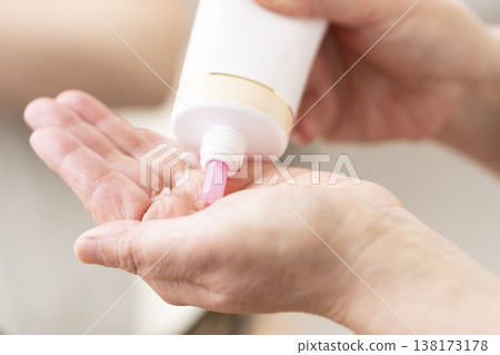 A woman's hands applying makeup. A woman's hands applying makeup. 138173178