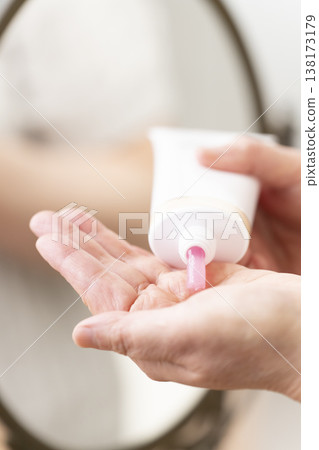 A woman's hands applying makeup. A woman's hands applying makeup. 138173179