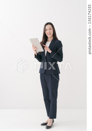 Smiling business woman doing a fist pump Smiling business woman doing a fist pump 138174285