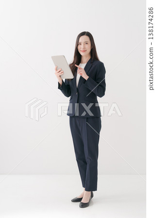 Smiling business woman doing a fist pump Smiling business woman doing a fist pump 138174286