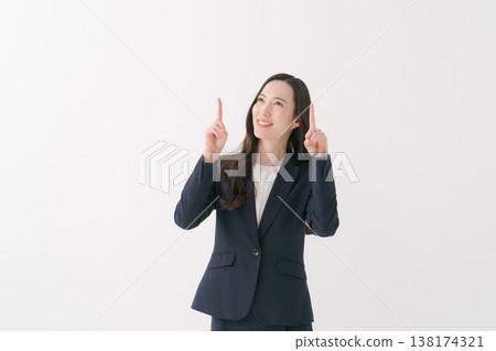 A smiling businesswoman pointing her finger A smiling businesswoman pointing her finger 138174321