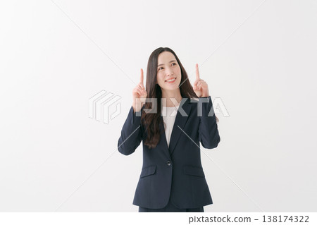 A smiling businesswoman pointing her finger 138174322
