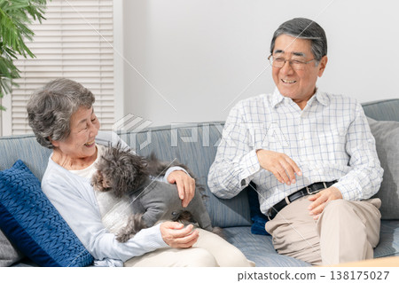 一對老年夫婦在客廳和他們的狗玩耍 138175027