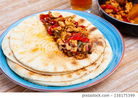 Chicken fajitas with peppers and onion served on tortillas Chicken fajitas with peppers and onion served on tortillas 138175399
