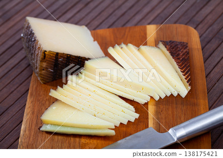 Slices of hard cheese Anejo from sheep milk 138175421
