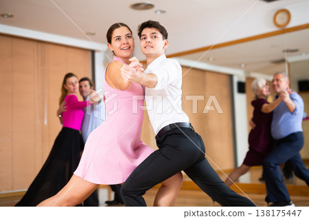 Young pair practicing ballroom dance in dance studio 138175447