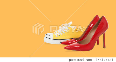 Two pairs of shoes sit side by side on a bright backdrop 138175481