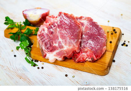 Sliced raw pork chop with parsley and onion Sliced raw pork chop with parsley and onion 138175516