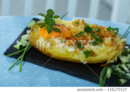 Baked potato with herbs, egg and cucumbers Baked potato with herbs, egg and cucumbers 138175527