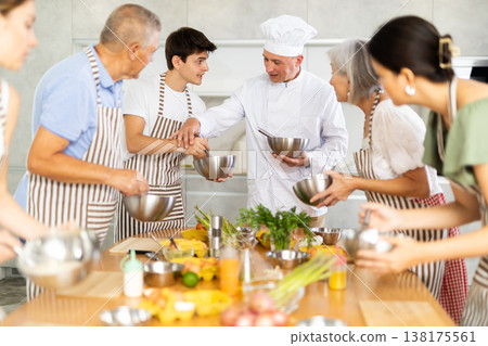 Smiling chef sharing secrets of cooking during culinary courses 138175561