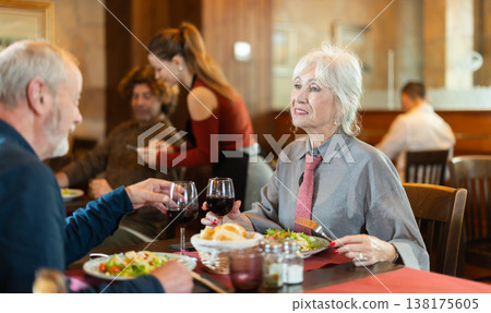 Mature couple communicate and chatting during date in cafe Mature couple communicate and chatting during date in cafe 138175605